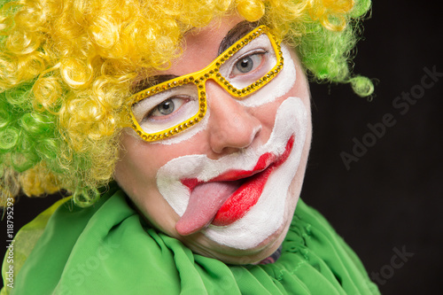 Fototapeta Naklejka Na Ścianę i Meble -  Funny clown in shiny glasses with good cheerful emotions