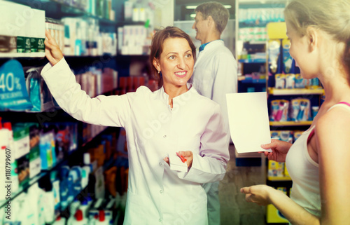 Female pharmacist in a white coat