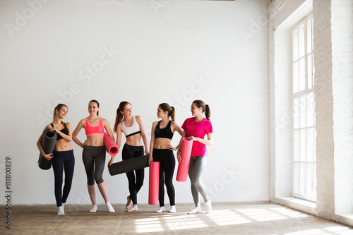 Smiling women in fitness studio.