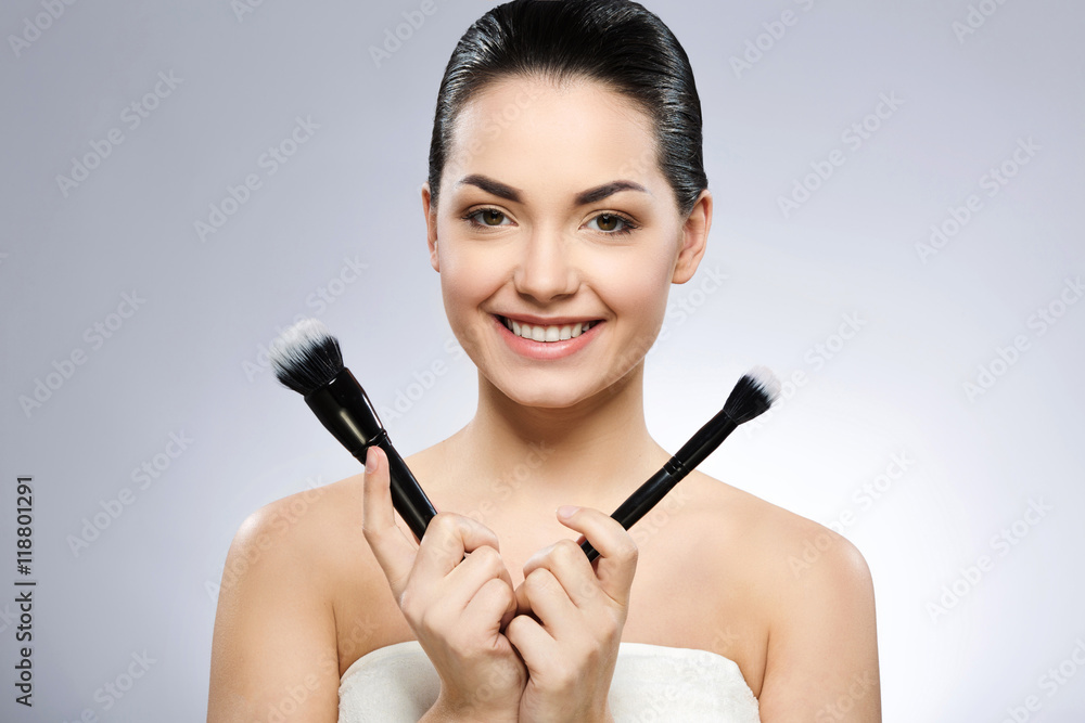 Lovely girl holding make up brushes Lovely girl holding make up brushes