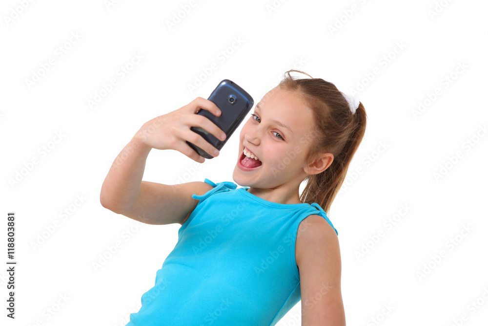 preteen girl with mobile phone taking a self-portrait preteen girl with mobile phone taking a self-portrait