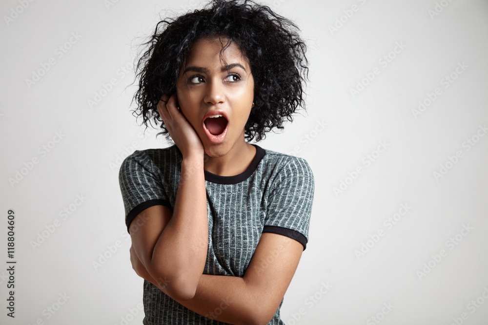 wondering black woman with curly short hair watching aside wondering black woman with curly short hair watching aside