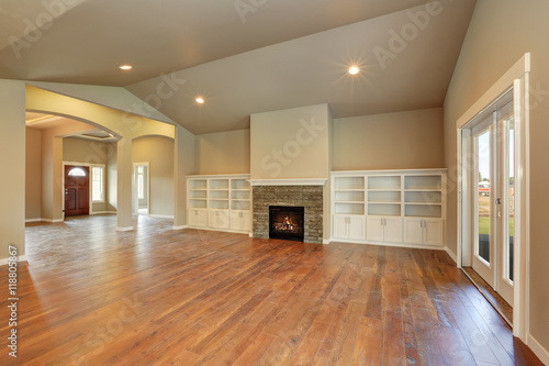 Spacious empty living room interior with vaulted ceiling