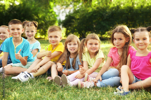 Happy kids sitting on grass...