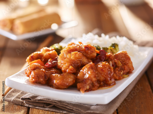 plate of chinese general tsos chicken with rice and broccoli