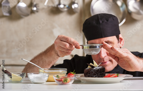 Restaurant hotel private chef preparing desert chocolate cake photo