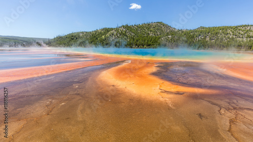 Beautiful Grand Prismatic Spring against blue sky in Midway Geyser Basin  Yellowstone National Park  Wyoming. Unusual colors of the lake.