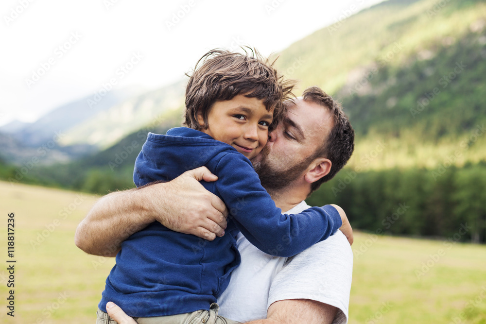 Father kissing his little son