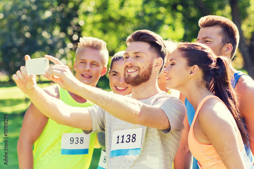 teenage sportsmen taking selfie with smartphone