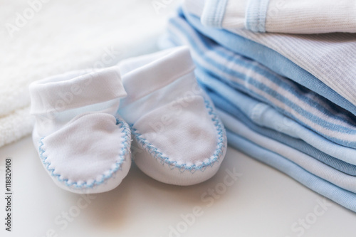 close up of baby bootees and clothes for newborn