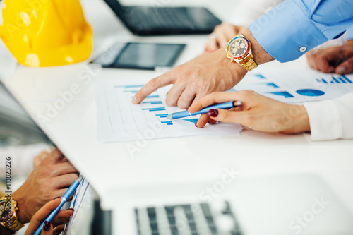 Close up of woman and man hand pointing at business document 