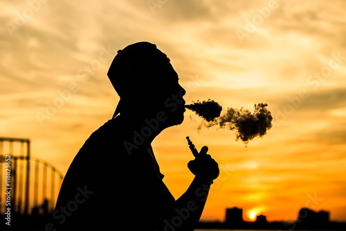 Silhouette of a vaper produces dads (smoke )