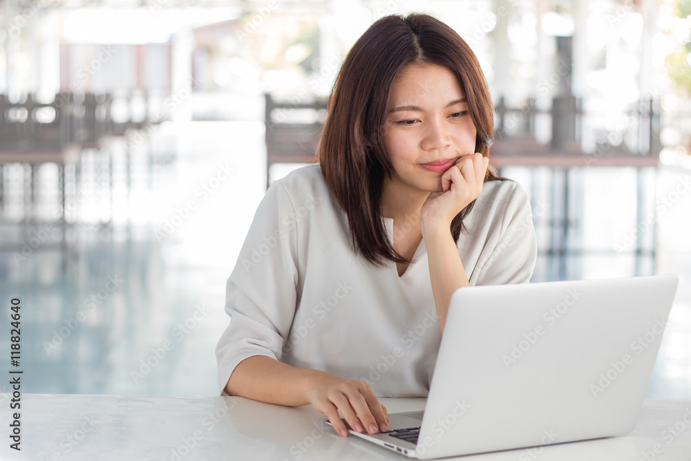 Woman using laptop computer with blurry background Woman using laptop computer with blurry background