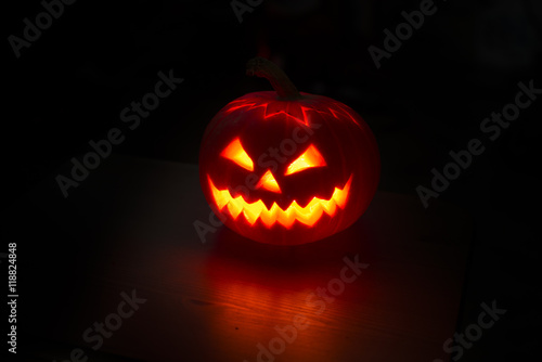 Illuminated halloween pumpkin on black background © littlej78