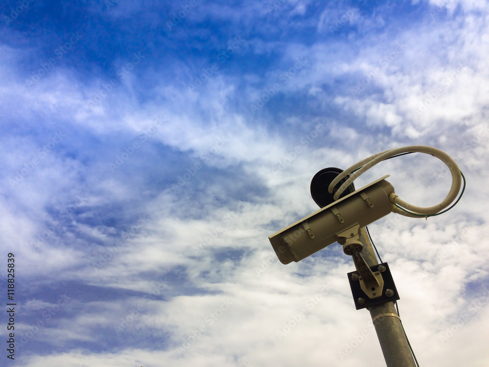 CCTV camera with cloud and blue sky.