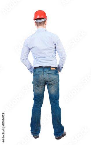 Backview of an engineer in construction helmet stands. Standing young guy. Rear view people collection.  backside view of person.  Isolated over white background. businessman in a white shirt and a © ghoststone