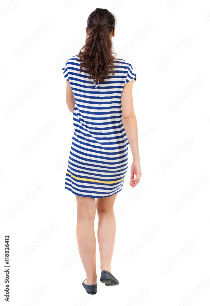 back view of walking curly woman. backside view of person. Rear view people collection. Isolated over white background. Swarthy girl in a checkered dress walks forward. back view of walking curly woman. backside view of person. Rear view people collection. Isolated over white background. Swarthy girl in a checkered dress walks forward.