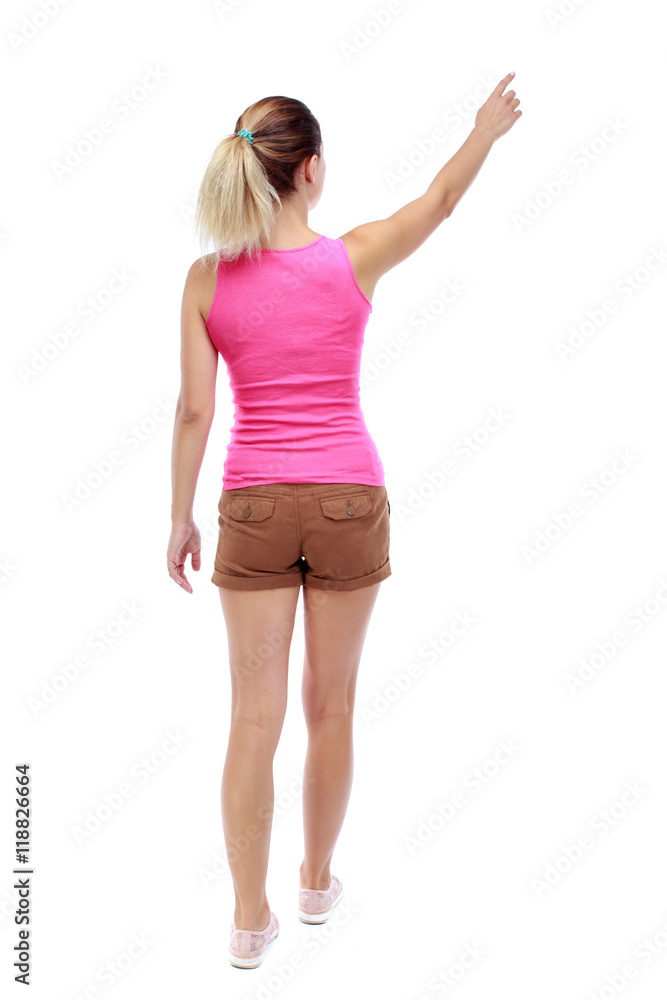 Back view of pointing woman. beautiful girl. Rear view people collection. backside view of person. Isolated over white background. Sport blond in brown shorts goes back frame showing thumb up. Back view of pointing woman. beautiful girl. Rear view people collection. backside view of person. Isolated over white background. Sport blond in brown shorts goes back frame showing thumb up.