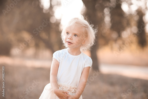Cute baby girl 2-3 year old wearing summer clothes posing outdoors. Childhood. Summer portrait.
