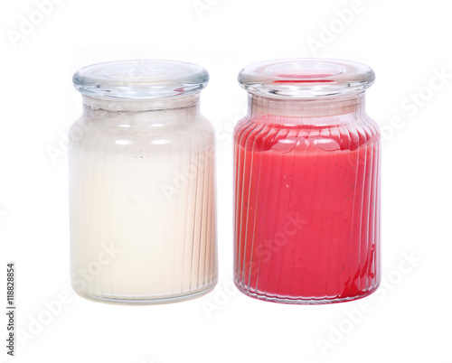 White and red candles in house warmer jar separated on white background