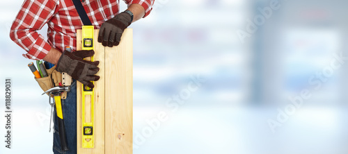 Builder with level and wooden planks.