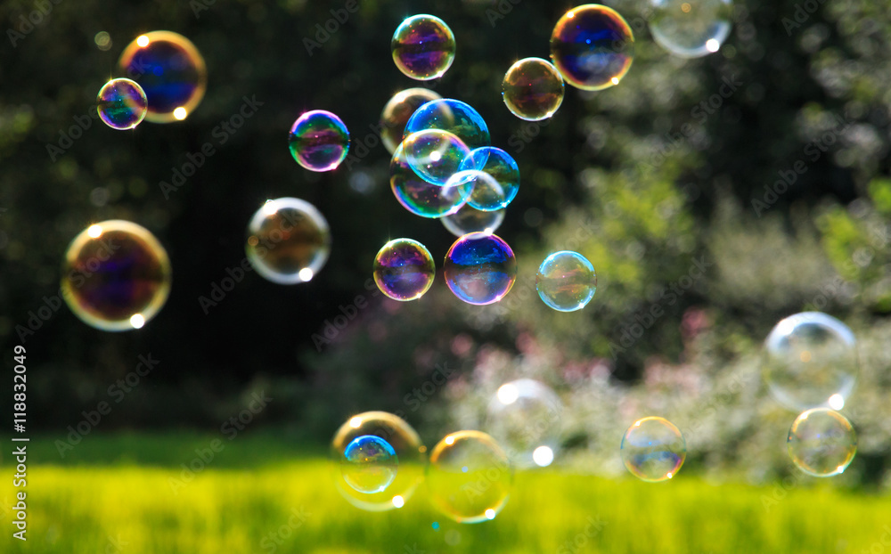 Colored soap bubbles against a green background