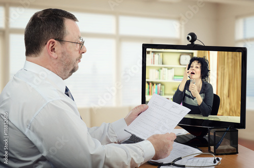 Woman takes pill under virtual supervising