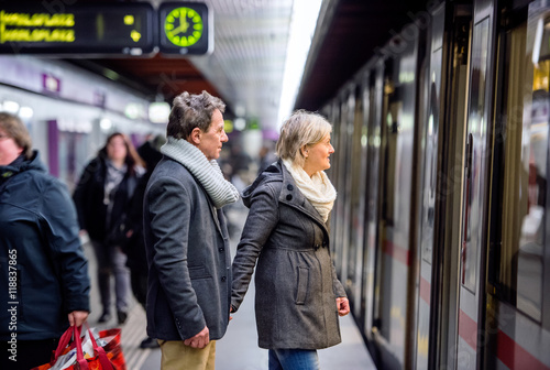Photography Senior couple standing at the underground platform, waiting