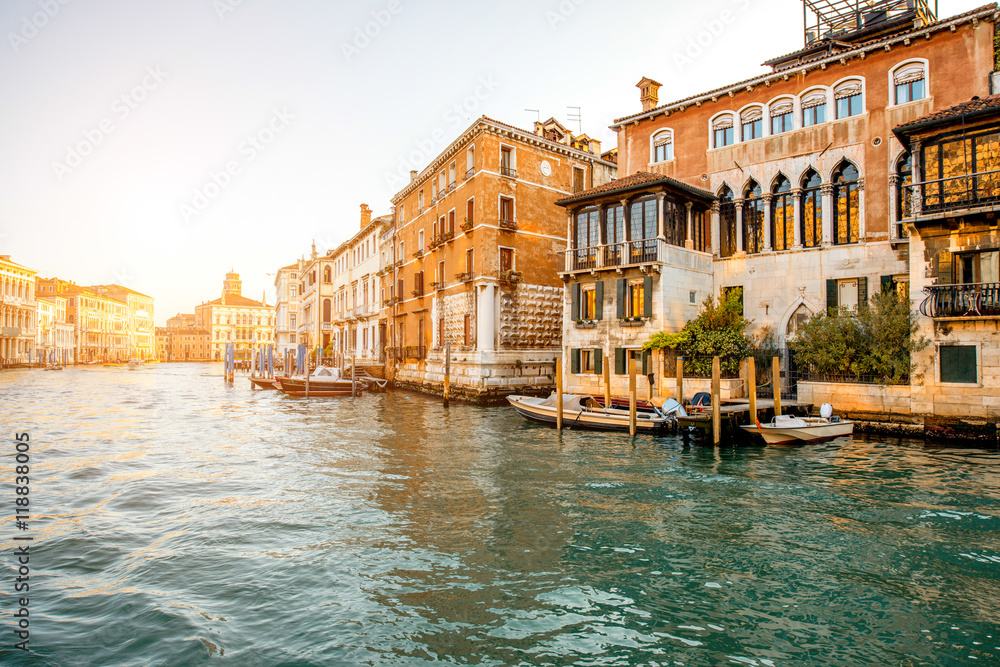Beautiful waterfront with colorful gothic buildings and boats on Gran canal at the sunrise