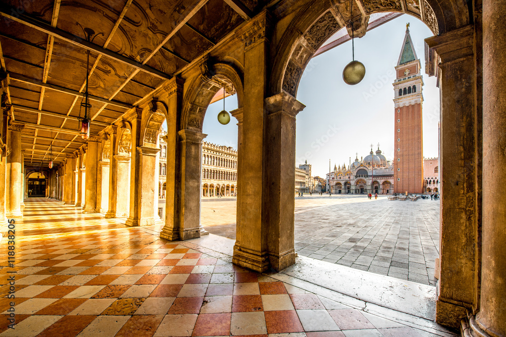 Fototapeta premium Arches of Correr museum with San Marco tower on the main square in the morning in Venice