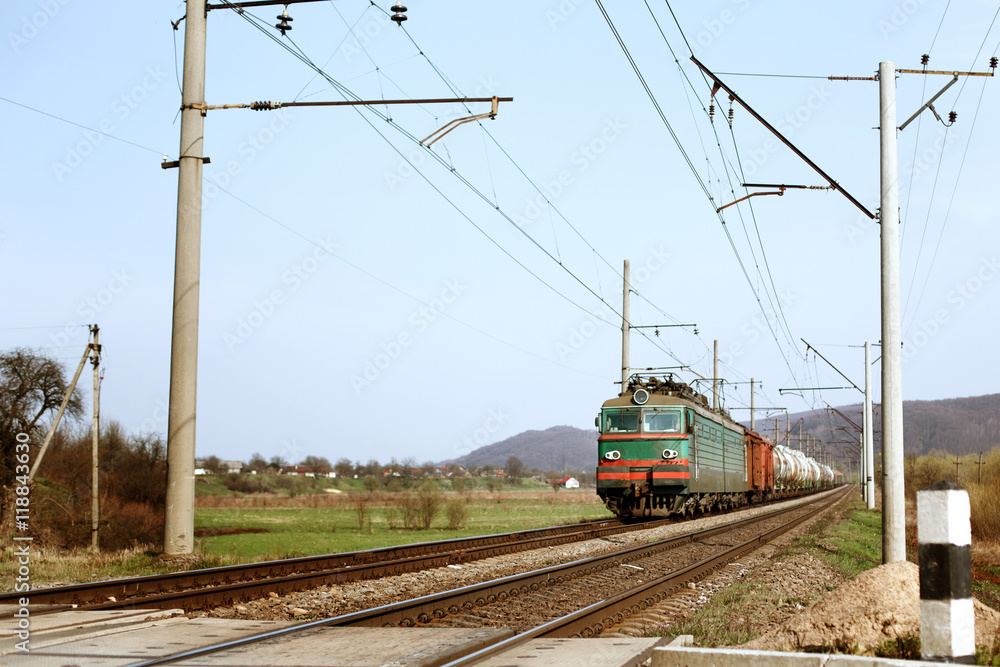 front of old train crossing railway and transporting goods carri