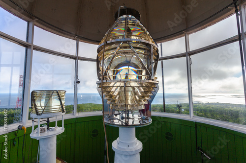 Lighthouse glass lamp and view on the sea