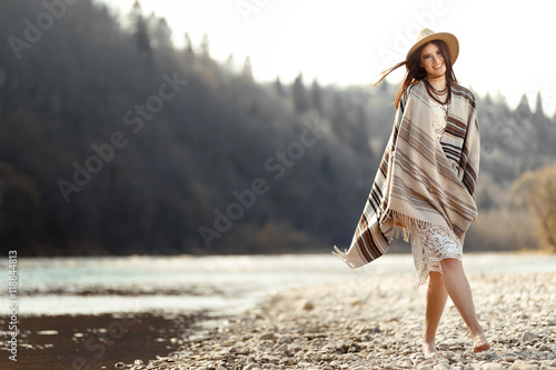 beautiful woman hipster walking on river beach in mountains, hav