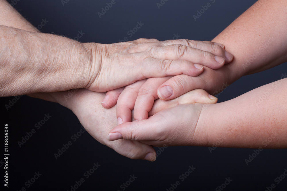 Hands of elderly and young women on black background Hands of elderly and young women on black background
