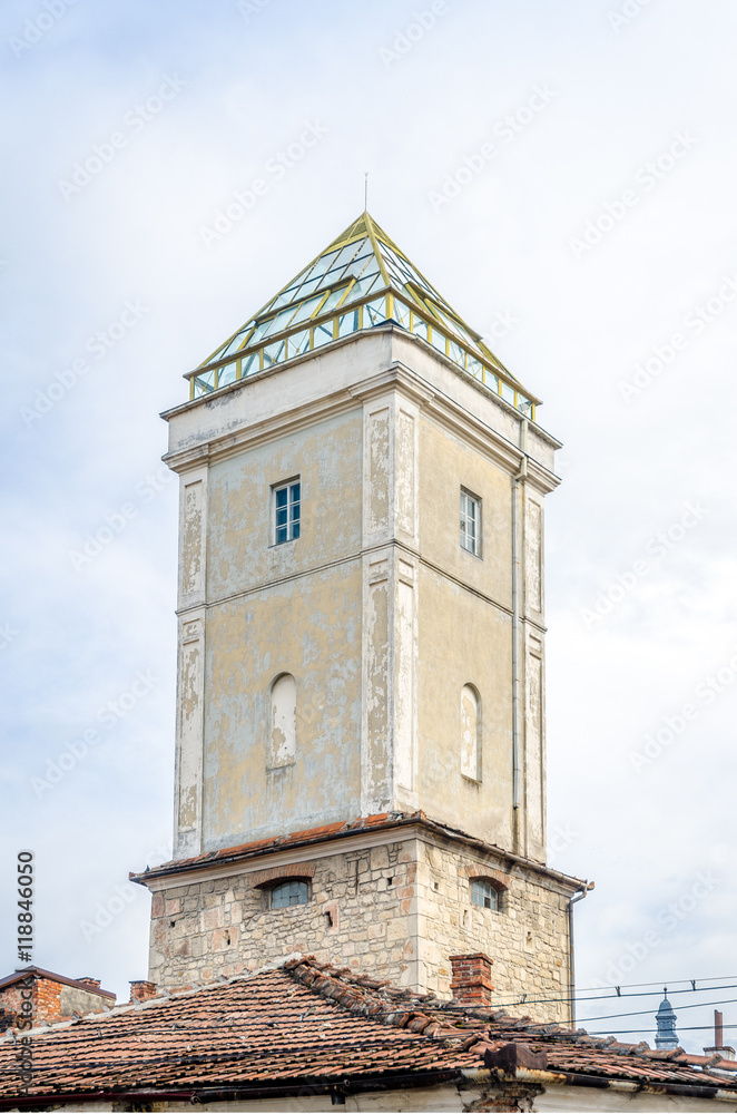 Fireman's tower in the medieval historic center of Cluj Napoca city in Transylvania region of Romania. A mixture of medieval, baroque and modern architecture with the pyramid on top