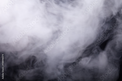 Cloud of smoke on black background. Selective focus