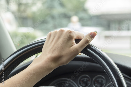 Wallpaper Mural Arm girls with trendy manicure holds the steering wheel in the car.  Torontodigital.ca