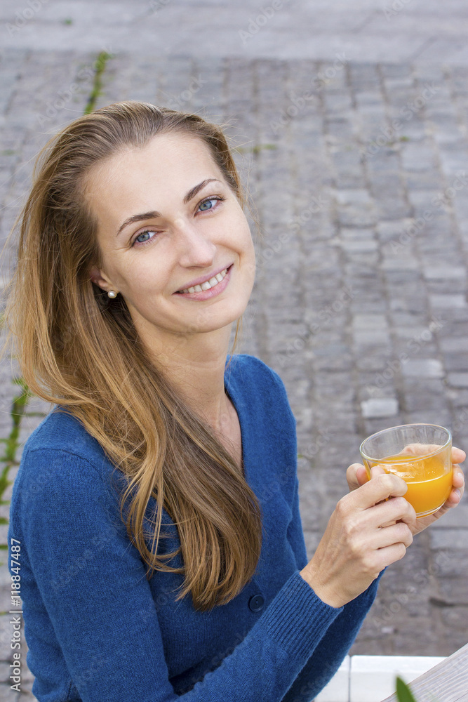 Woman with tea cup. Tea with sea buckthorn and honey on cafe bac Woman with tea cup. Tea with sea buckthorn and honey on cafe bac