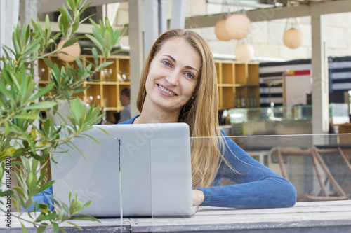 Woman with laptop outdoors. photo