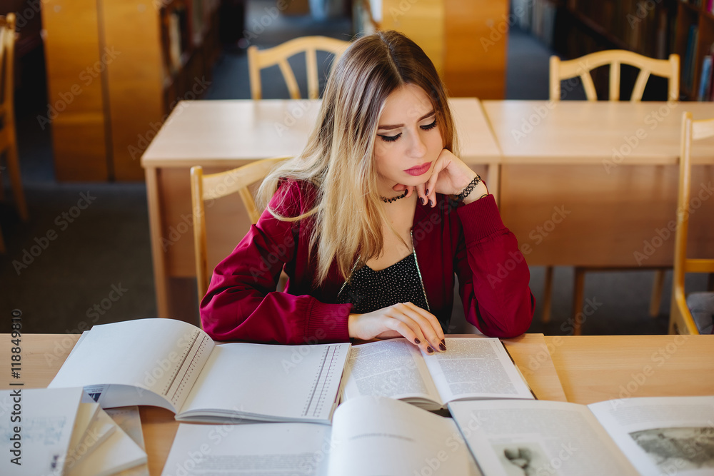 Bored and tired attractive female student sitting at desk in old ...