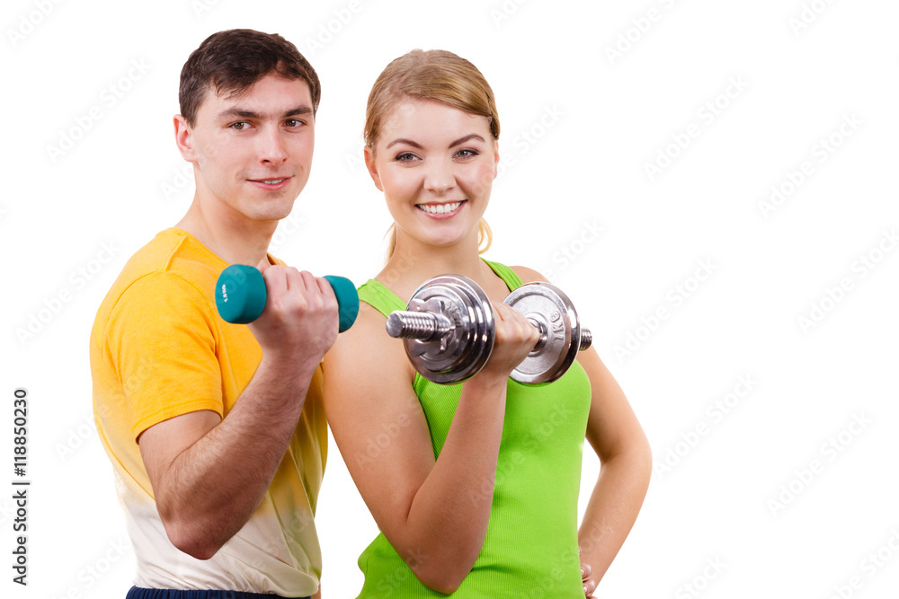 Couple exercising with dumbbells lifting weights