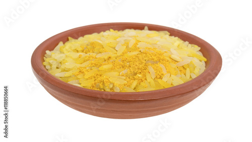 Saffron yellow rice in a bowl isolated on a white background.