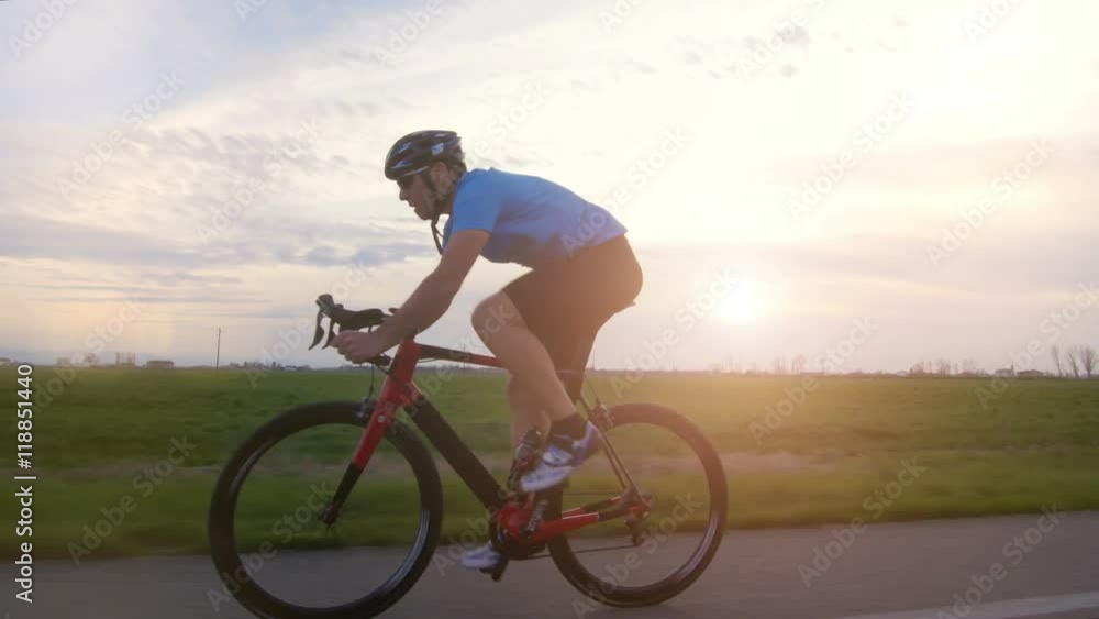 healthy man riding bike working out training fitness outdoor backlit at the sunset tracking shot from camera car
healthy man riding bike working out training fitness outdoor backlit at the sunset tracking shot from camera car