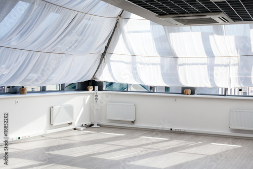 Interior of a room with big windows, sunlight on the floor