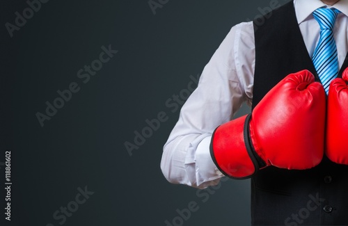 Boxing manager with red gloves on black background. © vchalup