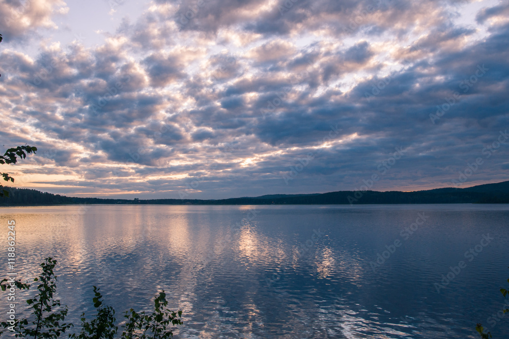 Fototapeta premium bright sunrise on the bank of forest lake
