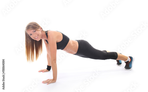 Athletic young woman practicing plank