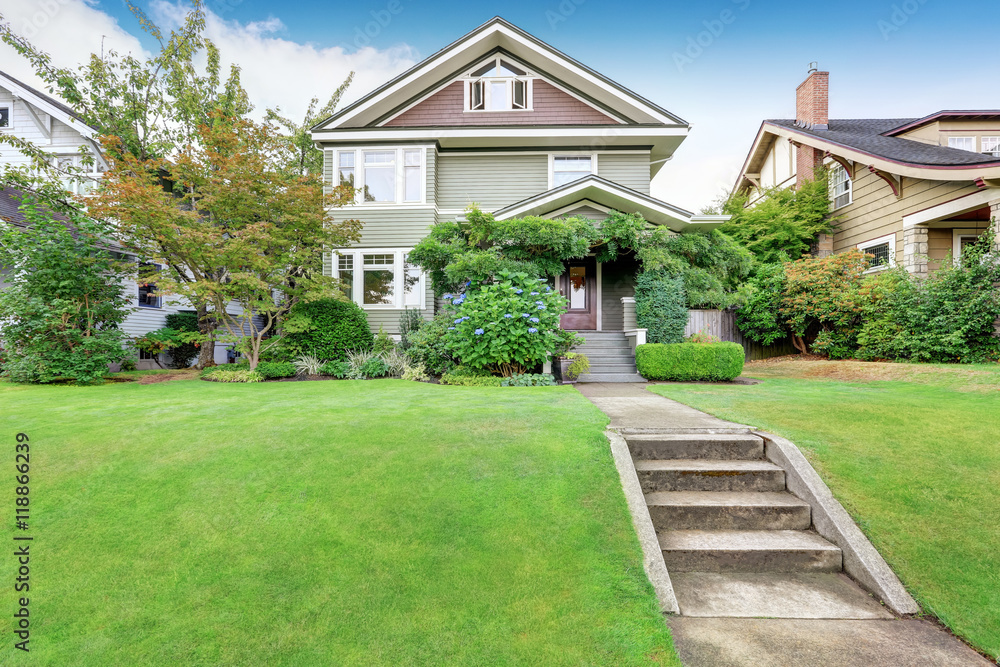 American family house exterior with perfectly kept lawn . American family house exterior with perfectly kept lawn .