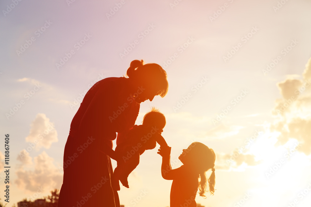 mother with two kids at sunset, happy family