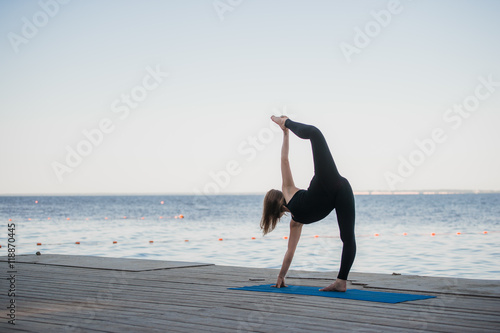 Image of a pretty woman doing yoga at the lake